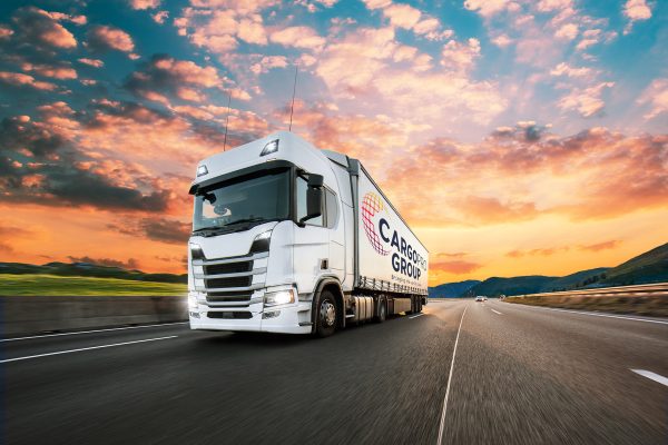 Truck with container on highway, cargo transportation concept. Shaving effect.